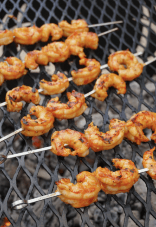 Grilled shrimp skewers on a grill grate.